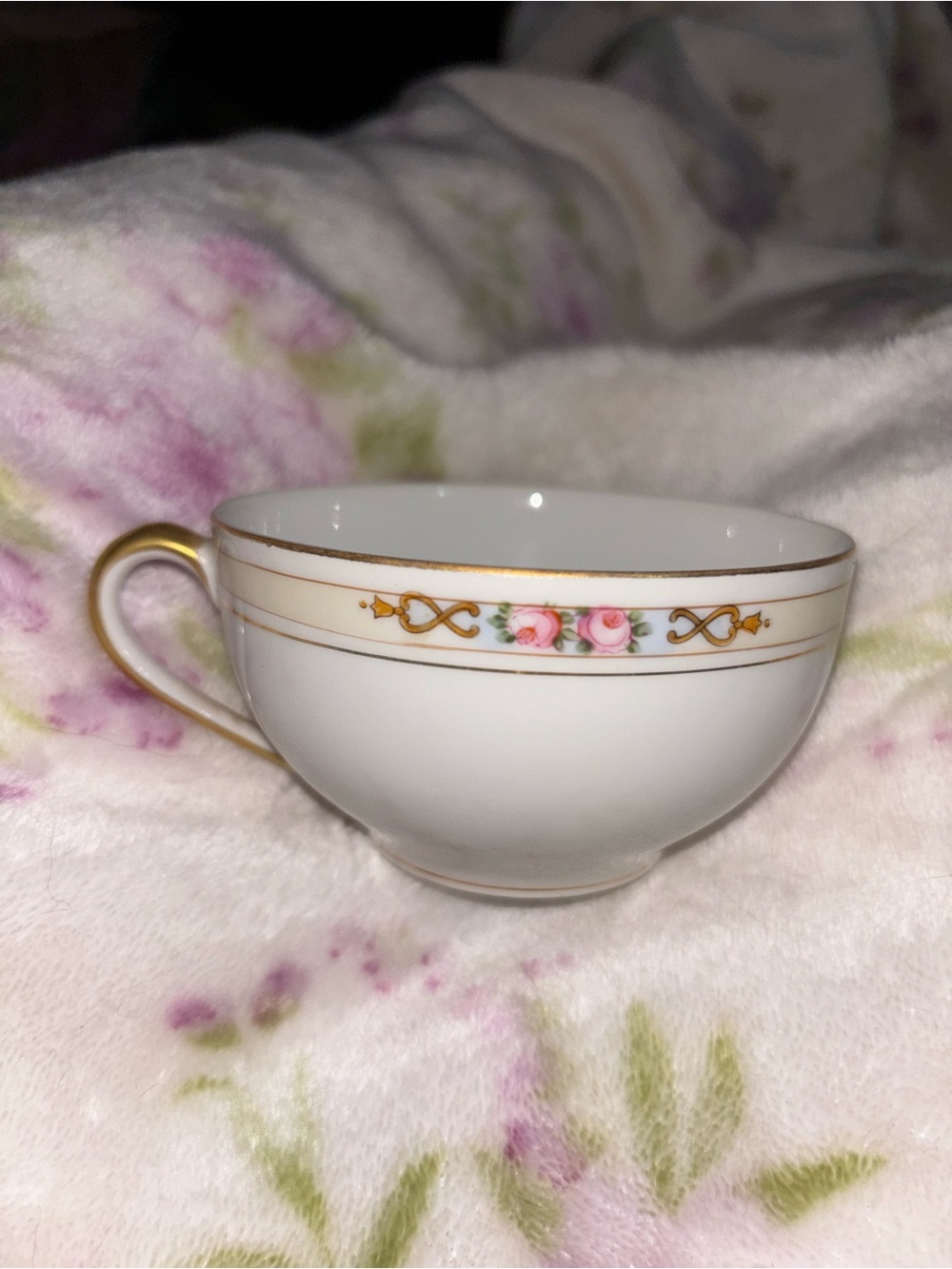 White Porcelain Teacup with Gold Trim and Pink Rose Detail